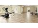 Exercise equipment in bonus room with wood-look floors and natural light from a wall of windows at 325 N Saint Phillip Ln, Alpharetta, GA 30022