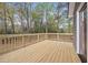 Close up of the light-colored backyard deck with wooded views at 7244 Valley Dr, Winston, GA 30187