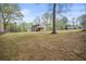Large backyard view showing the home with a deck in the distance at 7244 Valley Dr, Winston, GA 30187