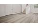 Finished basement with gray wood-look floors, white trim and door, and a stairway at 7244 Valley Dr, Winston, GA 30187