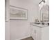 Bathroom with a granite vanity top, arched mirror, and brushed black hardware at 7244 Valley Dr, Winston, GA 30187