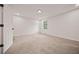 Spacious bedroom with plush carpeting, a large window for natural light, and fresh white paint at 7244 Valley Dr, Winston, GA 30187