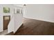 Inviting entryway featuring dark hardwood floors, fresh white paint and views through the living room windows at 7244 Valley Dr, Winston, GA 30187