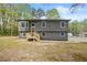 Beautifully renovated home with a modern gray exterior, large windows, and a welcoming front porch at 7244 Valley Dr, Winston, GA 30187