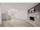 Spacious living room with wood-look floors, a stone fireplace feature and carpeted stairs at 7244 Valley Dr, Winston, GA 30187