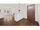 Light-filled living space showcasing dark hardwood floors, fresh white paint, and a view to the kitchen at 7244 Valley Dr, Winston, GA 30187