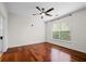 Bright bedroom features hardwood floors, a ceiling fan, and a large window at 10 Perimeter Summit Ne Blvd # 2110, Brookhaven, GA 30319