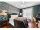 Charming bedroom featuring designer wallpaper, wood floors, a fan and large window for bright natural light at 10 Perimeter Summit Ne Blvd # 2110, Brookhaven, GA 30319