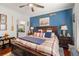 A primary bedroom features a king bed, fan, nautical décor, and a partial view of the en suite bathroom at 10 Perimeter Summit Ne Blvd # 2110, Brookhaven, GA 30319