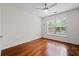 Bedroom with hardwood floors, ceiling fan and a large window at 10 Perimeter Summit Ne Blvd # 2110, Brookhaven, GA 30319