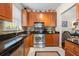 A modern kitchen features wooden cabinets, granite countertops, stainless steel appliances, and white marble-like flooring at 10 Perimeter Summit Ne Blvd # 2110, Brookhaven, GA 30319