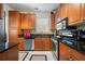 Well-lit kitchen boasts wooden cabinets, granite countertops, and stainless steel appliances, complemented by a tile backsplash at 10 Perimeter Summit Ne Blvd # 2110, Brookhaven, GA 30319