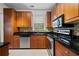 Kitchen with wood cabinets, granite countertops, stainless steel appliances, and tile backsplash at 10 Perimeter Summit Ne Blvd # 2110, Brookhaven, GA 30319