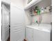 A functional laundry room equipped with a washer, dryer, and convenient overhead shelving at 10 Perimeter Summit Ne Blvd # 2110, Brookhaven, GA 30319