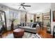 Comfortable living room featuring hardwood floors, a cozy sofa, and large windows at 10 Perimeter Summit Ne Blvd # 2110, Brookhaven, GA 30319