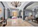 Welcoming building lobby with a chandelier, tiled floors, seating and muted gray paint at 10 Perimeter Summit Ne Blvd # 2110, Brookhaven, GA 30319