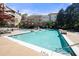 Large, clean community pool surrounded by lounge chairs and lush landscaping at 10 Perimeter Summit Ne Blvd # 2110, Brookhaven, GA 30319