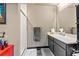 Contemporary bathroom featuring a vanity with storage, a framed mirror, a shower with glass door, and grey tile at 115 W Peachtree Nw Pl # 304, Atlanta, GA 30313