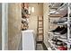 Organized walk-in closet with ladder, shoe racks, and storage, plus space for in-unit laundry with washer at 115 W Peachtree Nw Pl # 304, Atlanta, GA 30313