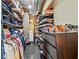 Walk-in closet with custom shelving for clothes, shoes, and accessories, plus space for laundry appliances at 115 W Peachtree Nw Pl # 304, Atlanta, GA 30313