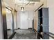 Apartment hallway with gray walls, concrete floors, and industrial-chic decor at 115 W Peachtree Nw Pl # 304, Atlanta, GA 30313