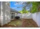 Fenced backyard featuring a small patio with sliding door and exterior building at 1164 Britley Park Ln, Woodstock, GA 30189