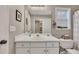 Bathroom featuring a shower over tub, ample storage, and large mirror at 1164 Britley Park Ln, Woodstock, GA 30189