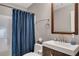 Bathroom featuring a shower with blue curtain, a modern sink, and decorative mirror at 1164 Britley Park Ln, Woodstock, GA 30189