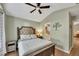 Bedroom with a bed with upholstered headboard and doorway to bath at 1164 Britley Park Ln, Woodstock, GA 30189
