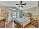 Bedroom featuring a bed with upholstered headboard and bay window at 1164 Britley Park Ln, Woodstock, GA 30189
