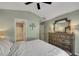 Bedroom featuring a bed with upholstered headboard, dresser and bath access at 1164 Britley Park Ln, Woodstock, GA 30189