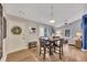 Cozy dining area with hardwood floors, an entrance to the living room, and outdoor patio access at 1164 Britley Park Ln, Woodstock, GA 30189