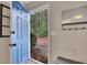 A blue front door leads to a foyer with hardwood floors, a mirror and a bench at 1164 Britley Park Ln, Woodstock, GA 30189