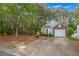 View of a single story home with brick accents, one car garage and a long driveway at 1164 Britley Park Ln, Woodstock, GA 30189