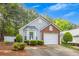 Charming single-story home with brick accents, manicured landscaping, and attached one car garage at 1164 Britley Park Ln, Woodstock, GA 30189