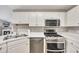 Kitchen with stainless steel appliances and white cabinetry providing modern appeal at 1164 Britley Park Ln, Woodstock, GA 30189