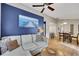 Bright living room featuring wood floors, blue accent wall, and modern furnishings at 1164 Britley Park Ln, Woodstock, GA 30189