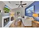 Cozy living room with a fireplace, ceiling fan and hardwood floors at 1164 Britley Park Ln, Woodstock, GA 30189