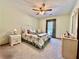 Cozy carpeted bedroom with a ceiling fan, one window, a bed, nightstand, lamp, and a dresser at 1552 Longwood Dr, Lawrenceville, GA 30043