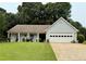 Charming single-story home with a well-manicured lawn and attached two-car garage at 1552 Longwood Dr, Lawrenceville, GA 30043