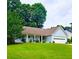 Charming home with a well-maintained lawn, flower beds, and a two-car garage at 1552 Longwood Dr, Lawrenceville, GA 30043