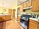 Bright kitchen with wood cabinets, white countertops, stainless steel appliances, and wood laminate flooring at 1552 Longwood Dr, Lawrenceville, GA 30043