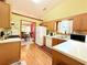 Functional kitchen with oak cabinets and modern appliances open to the dining room at 1552 Longwood Dr, Lawrenceville, GA 30043
