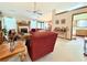 Open living room with a fireplace, ceiling fan, and ample natural light at 1552 Longwood Dr, Lawrenceville, GA 30043