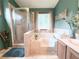 Bathroom featuring a shower, soaking tub, vanity with sink, wood cabinets, and large mirror at 1552 Longwood Dr, Lawrenceville, GA 30043