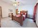 Primary bedroom with carpet, ceiling fan, accent chair, bedside tables, queen bed, and natural light at 1552 Longwood Dr, Lawrenceville, GA 30043