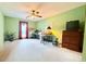 Large carpeted office or bedroom with window, ceiling fan, and desk, along with extra floor space at 1552 Longwood Dr, Lawrenceville, GA 30043
