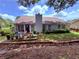 Back patio with outdoor seating, potted plants, and a well-maintained lawn at 1552 Longwood Dr, Lawrenceville, GA 30043