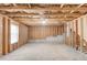 A large, unfinished basement with exposed wood and concrete flooring at 2045 Villa Spring Ct, Dacula, GA 30019