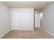 Comfortable bedroom with neutral carpet, and neutral walls with two doors at 2045 Villa Spring Ct, Dacula, GA 30019